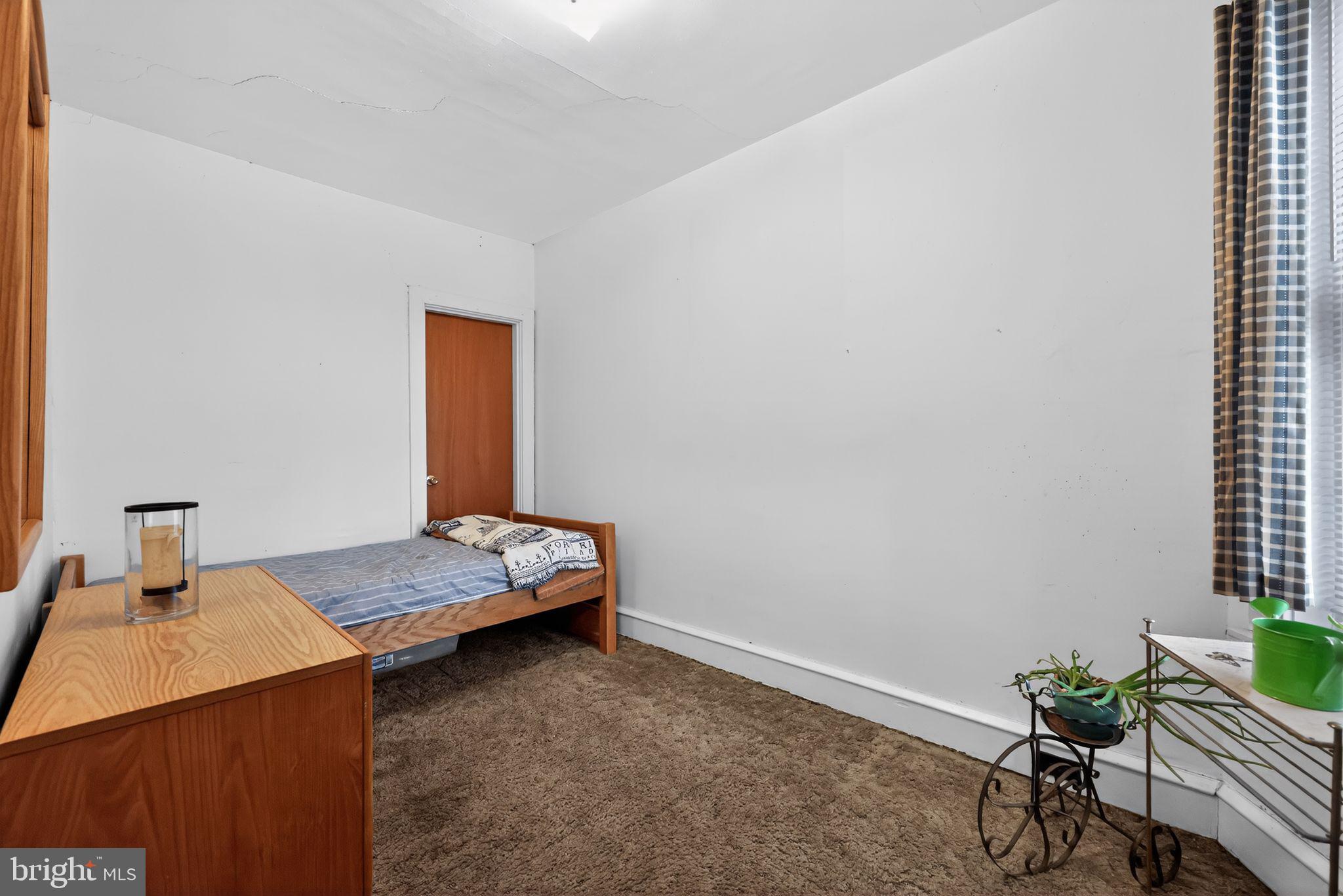 3067 Cedar Street Philadelphia, PA 19134 - Photo 24 of 30 a bedroom with a bed and a table in it