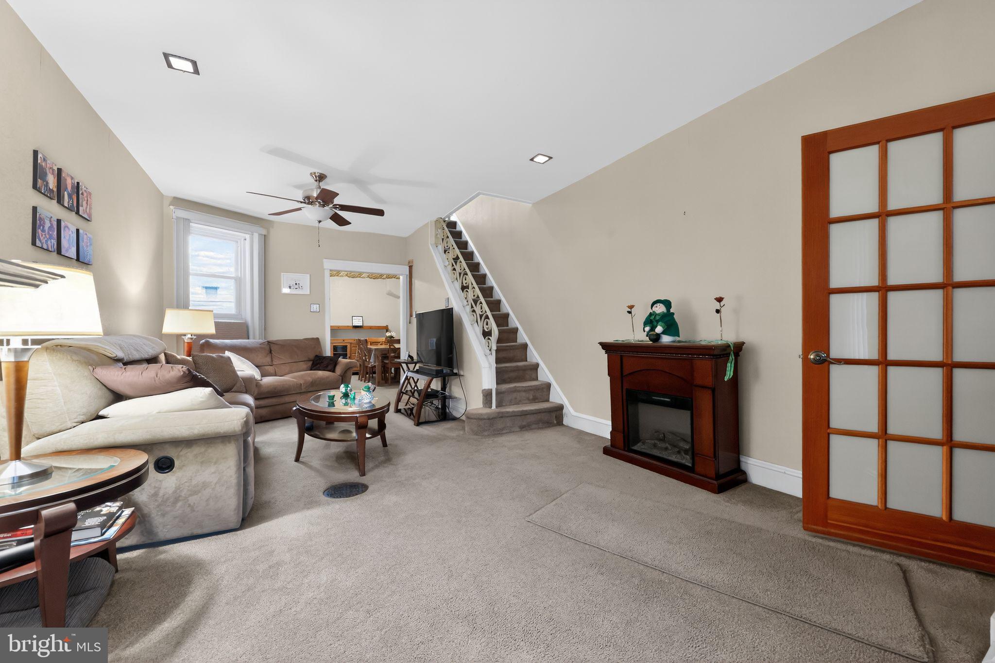 3067 Cedar Street Philadelphia, PA 19134 - Photo 6 of 30 a living room with furniture a fireplace and a large window