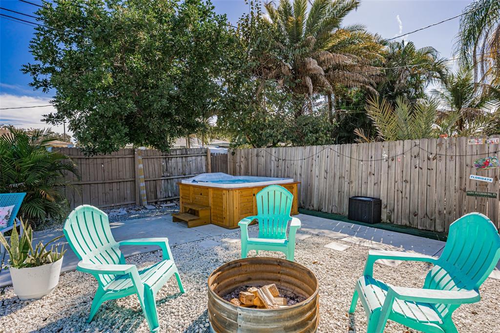 4939 100th Way North St. Petersburg, FL 33708 - Photo 33 of 43 a view of a backyard with a tub and a fire pit