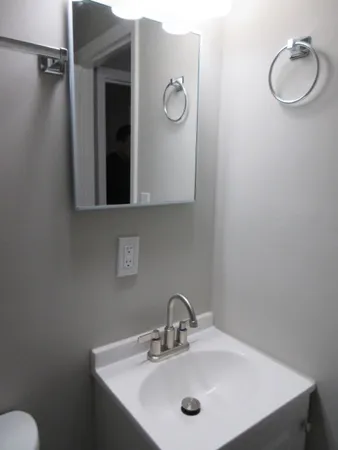 a bathroom with a sink vanity and a mirror