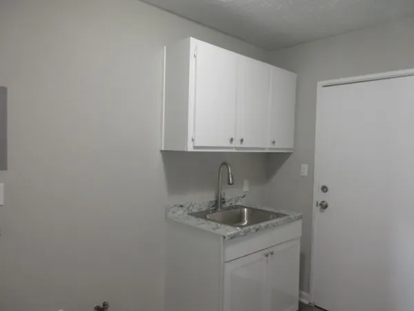 a kitchen with a sink and cabinets