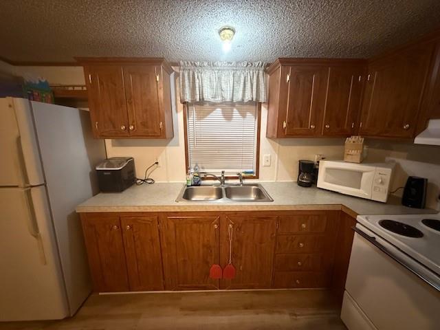 641 Sky Camp Loop, Unit 12 Graford, TX 76449 - Photo 12 of 14 a kitchen with a refrigerator a stove a sink and a cabinets