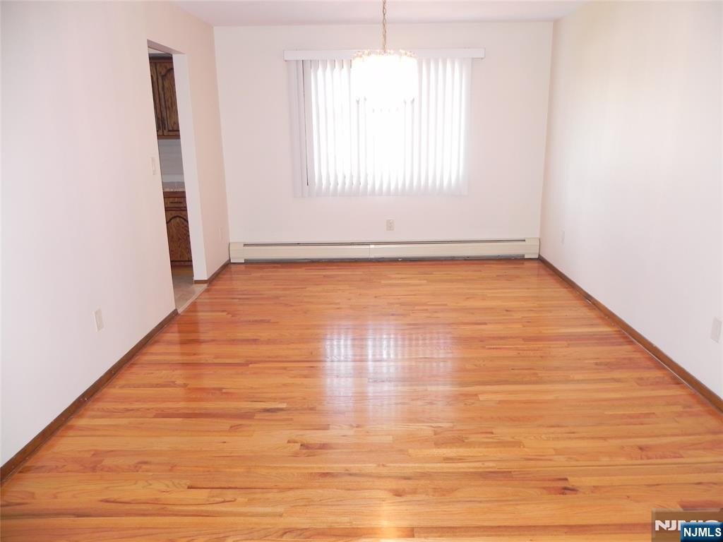 52 Wilson Street, Unit 2 Little Ferry, NJ 07643 - Photo 3 of 11 an empty room with wooden floor and windows