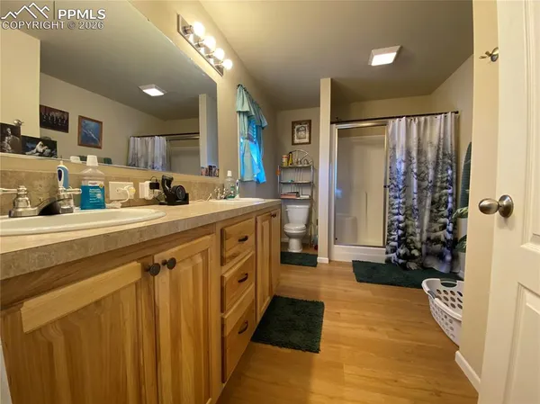 a bathroom with a granite countertop sink toilet a shower and a mirror