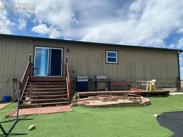 a balcony with furniture and a garden