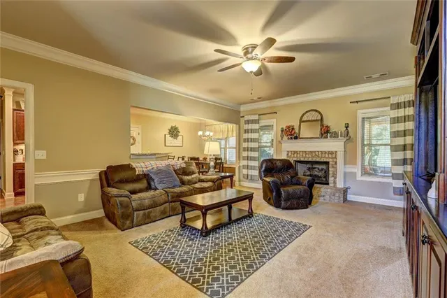 a living room with furniture fireplace and a table
