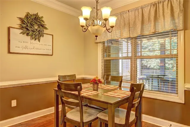a view of a dining room with furniture and a window