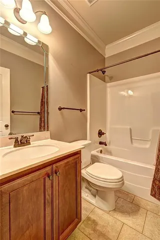 a bathroom with a sink a toilet a mirror and shower