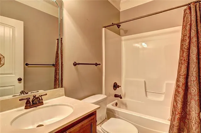 a bathroom with a sink toilet tub and shower