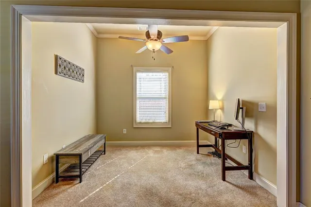 a view of a workspace with furniture and a window