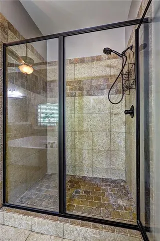 a bathroom with a glass shower door