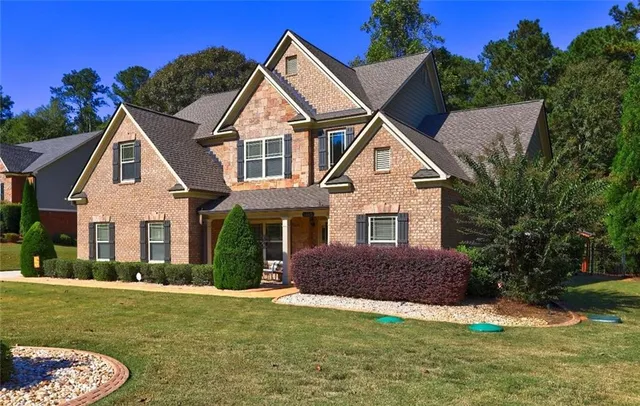 a front view of a house with a yard