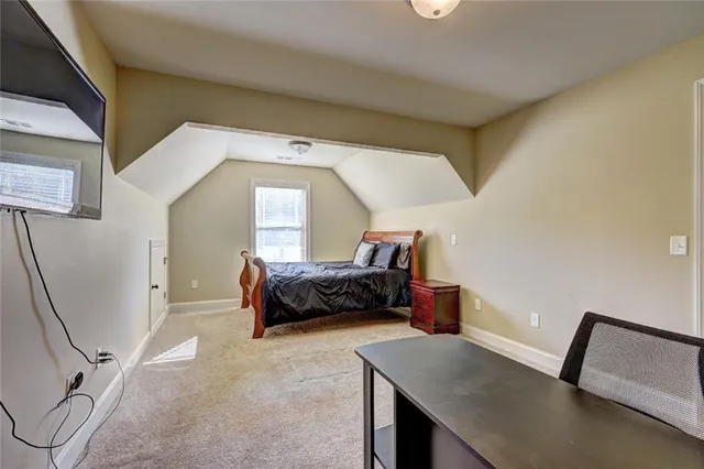 a bedroom with a bed and a couch