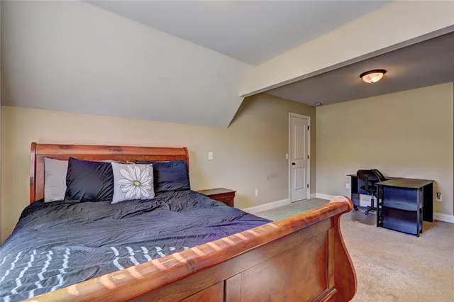 a bedroom with a bed and a piano in it