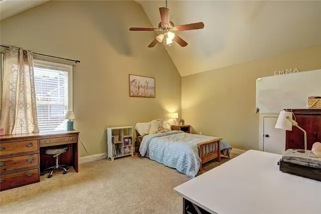 a bedroom with two beds and a window