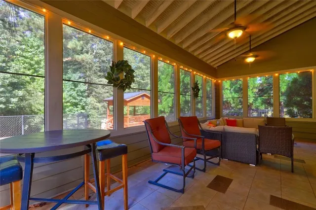 a dining room with furniture a chandelier and wooden floor