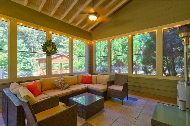 a living room with furniture and a floor to ceiling window