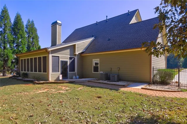 a view of a house with backyard and sitting area