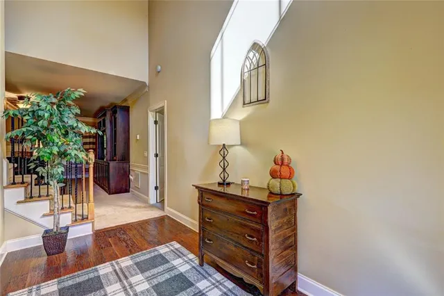 a room with wooden floor and potted plant