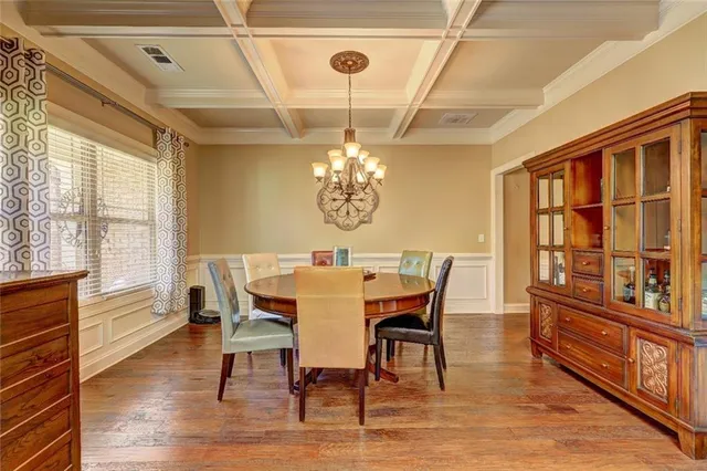 a dining room with furniture a window and wooden floor