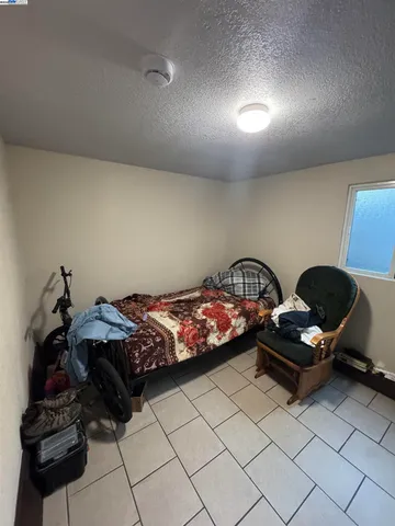 a bedroom with a bed and a mirror