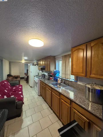 a kitchen with stainless steel appliances granite countertop a sink stove and cabinets