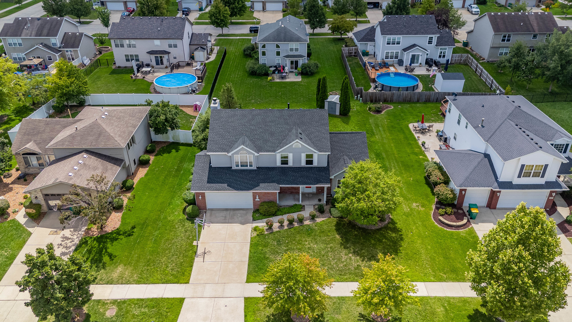an aerial view of multiple houses with yard