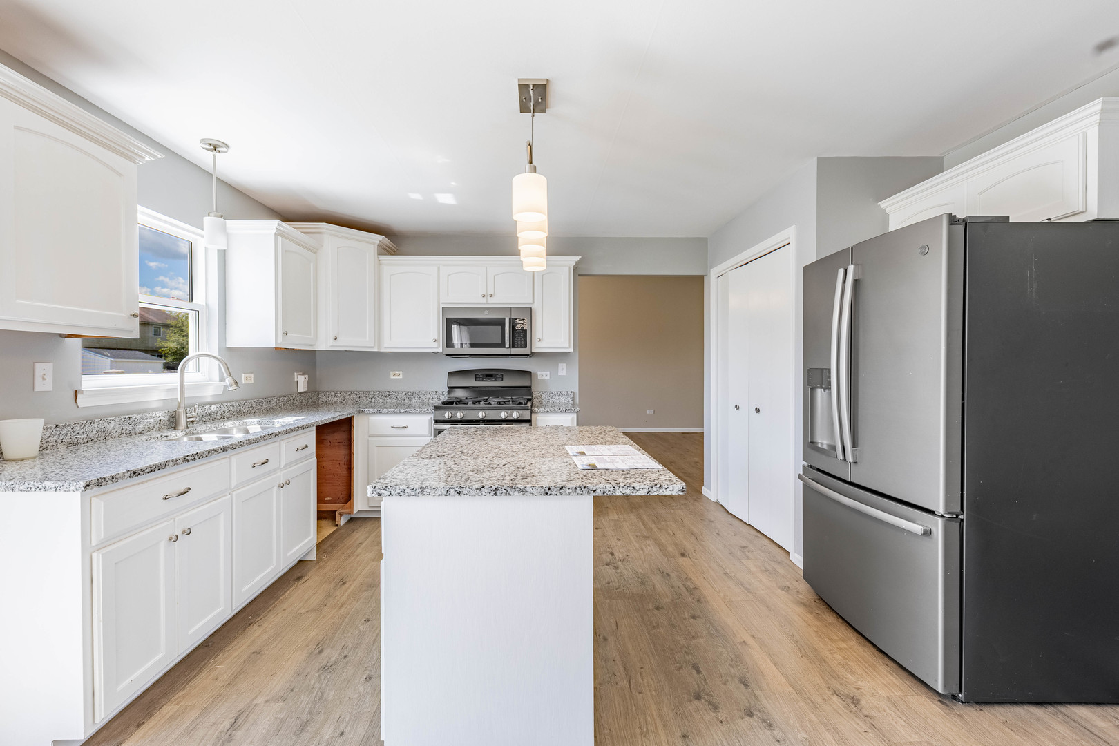 16263 Celtic Circle Manhattan, IL 60442 - Photo 14 of 45 a kitchen with granite countertop a refrigerator and a sink