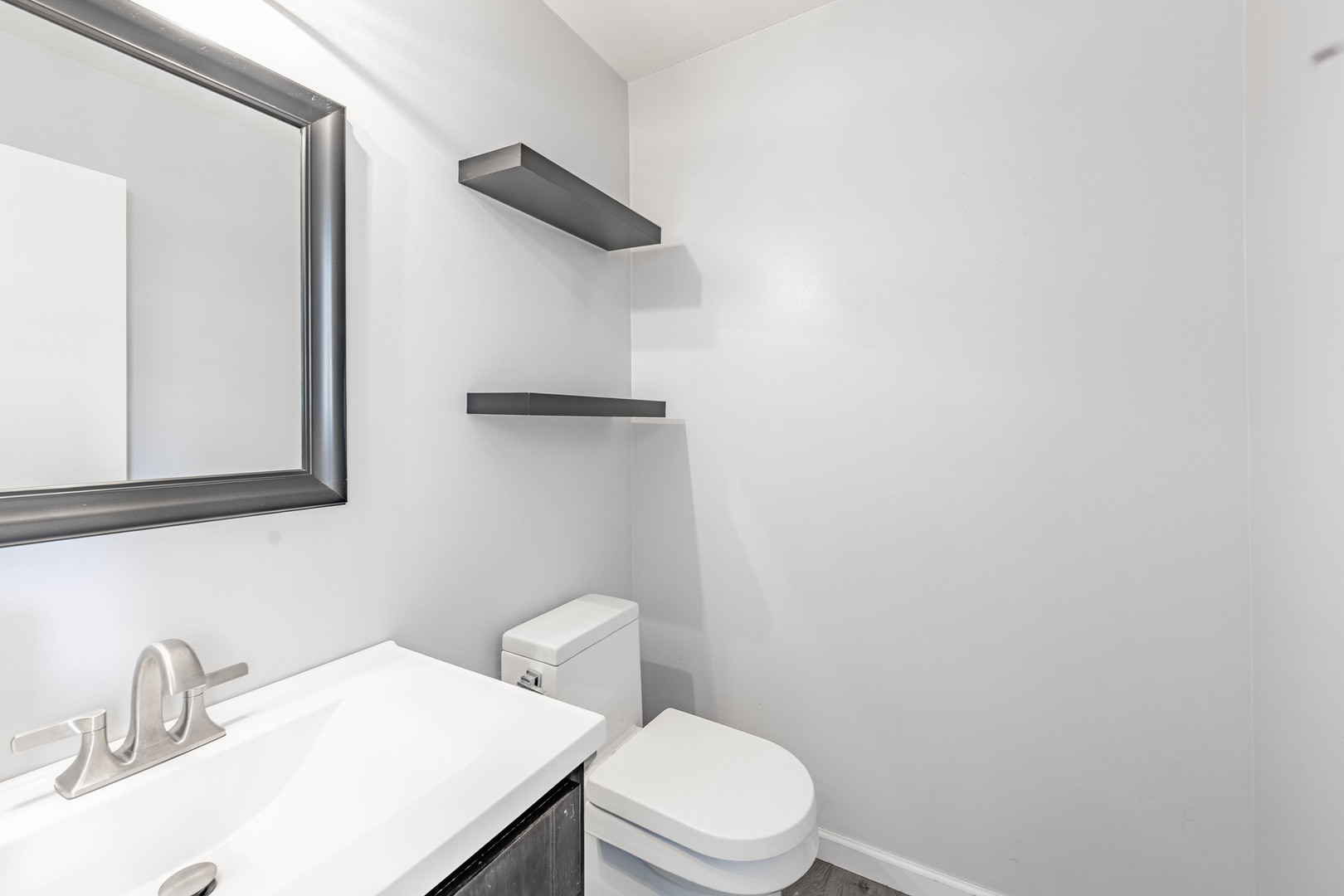 16263 Celtic Circle Manhattan, IL 60442 - Photo 18 of 45 a bathroom with a sink a toilet and mirror