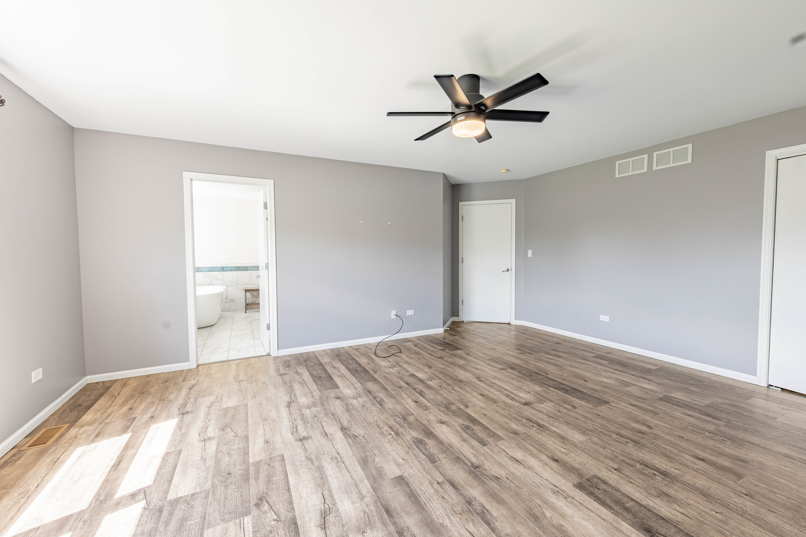 16263 Celtic Circle Manhattan, IL 60442 - Photo 30 of 45 a view of empty room with wooden floor and fan