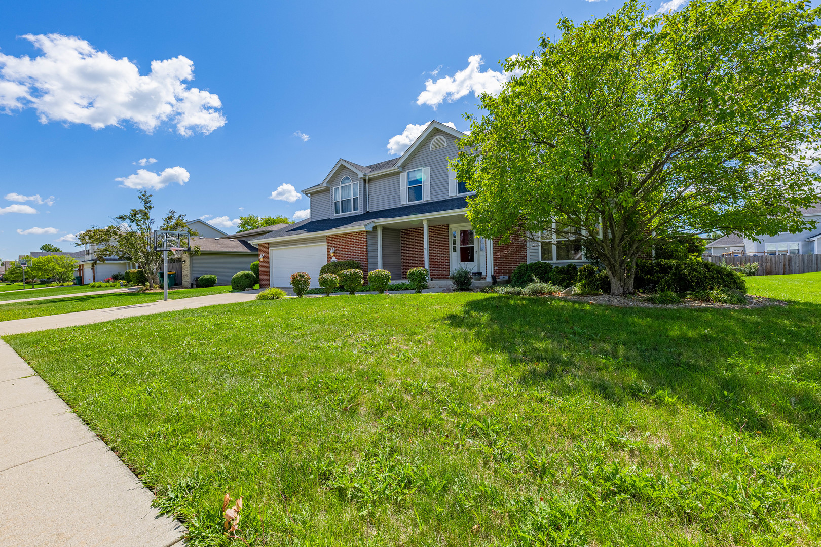 16263 Celtic Circle Manhattan, IL 60442 - Photo 3 of 45 a front view of a house with garden and trees