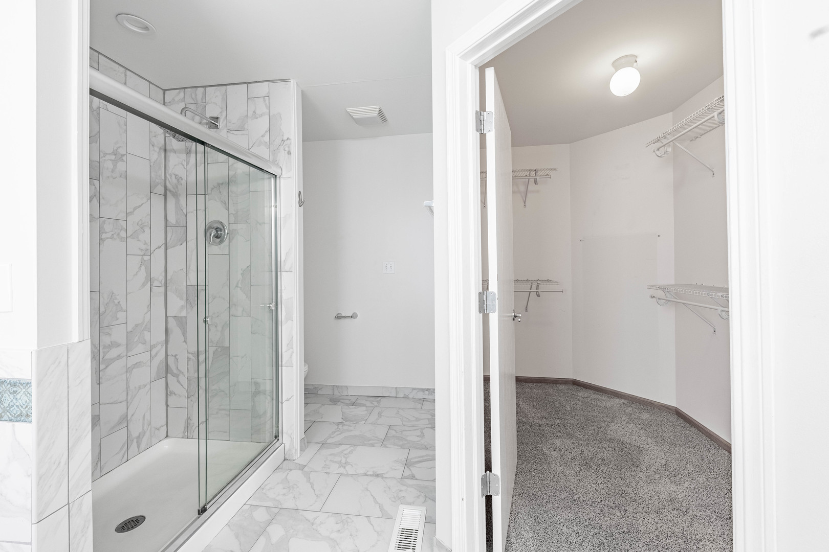 16263 Celtic Circle Manhattan, IL 60442 - Photo 35 of 45 a bathroom with a shower and a glass door