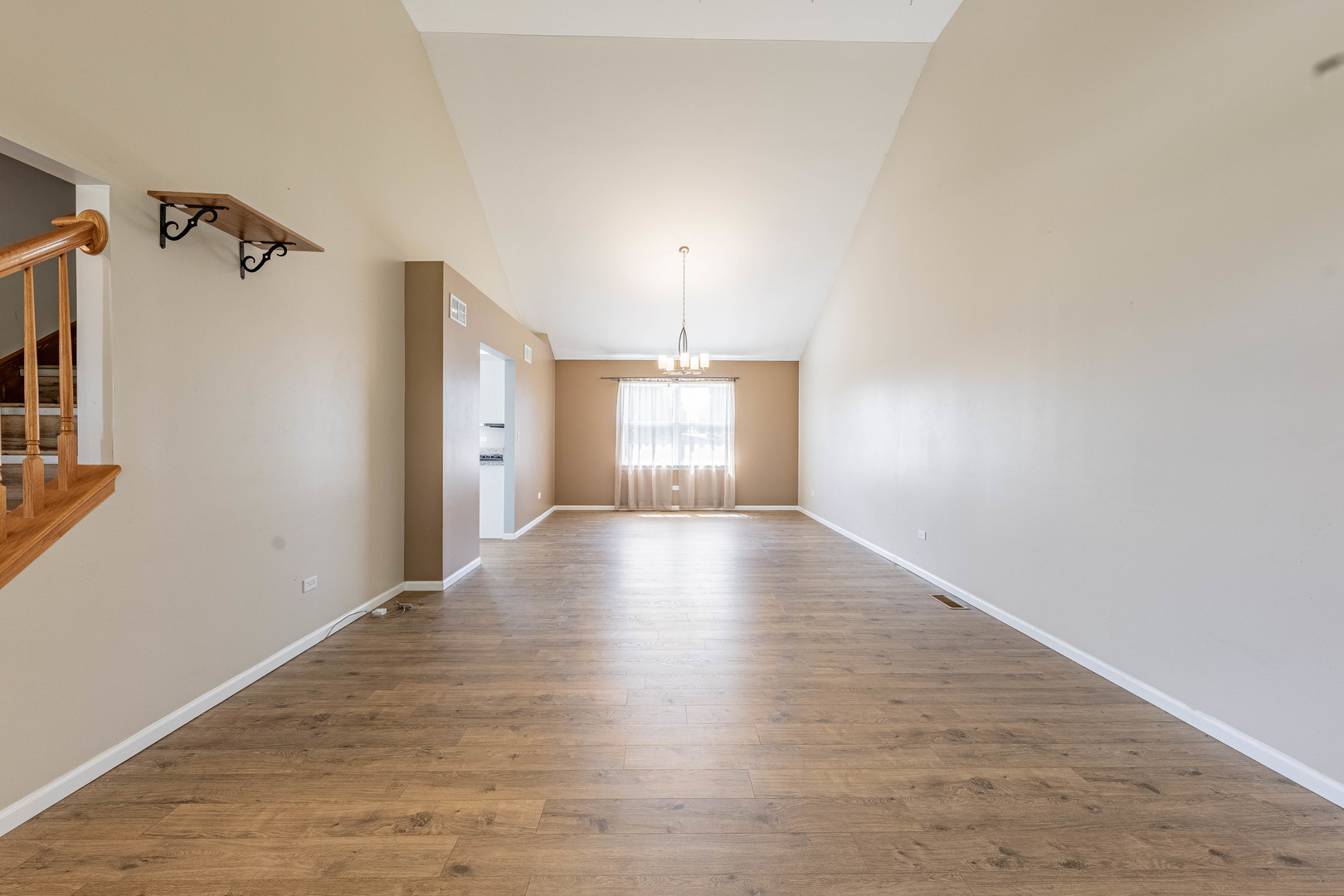 16263 Celtic Circle Manhattan, IL 60442 - Photo 7 of 45 a view of an empty room with window and wooden floor