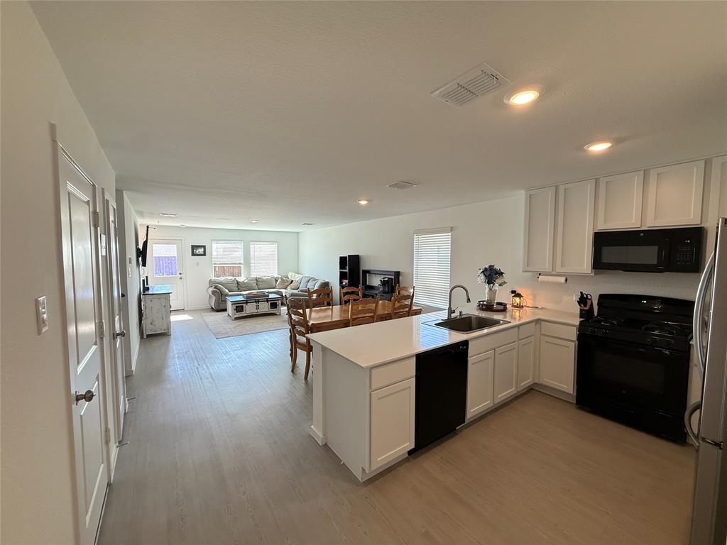 14120 Hammersmith Street Pilot Point, TX 76258 - Photo 2 of 12 a kitchen with stove and refrigerator
