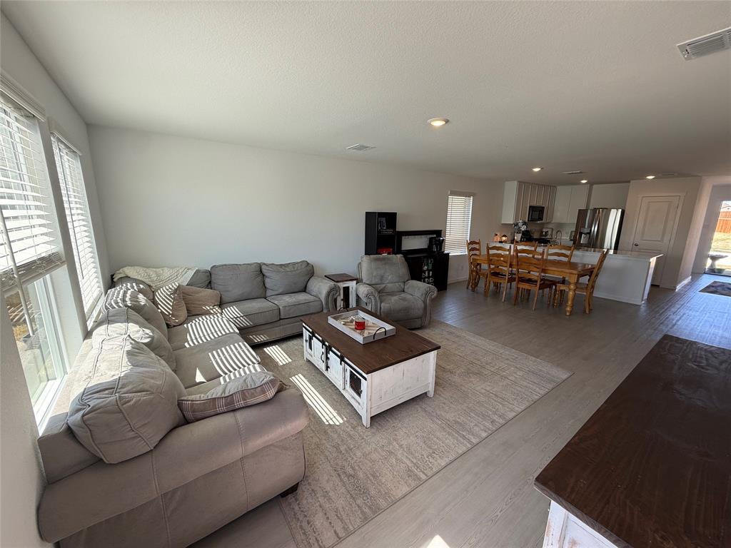 14120 Hammersmith Street Pilot Point, TX 76258 - Photo 3 of 12 a living room with furniture and a dining table