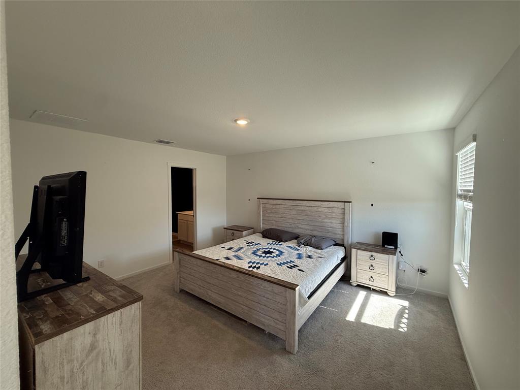 14120 Hammersmith Street Pilot Point, TX 76258 - Photo 4 of 12 a bedroom with a bed and dresser