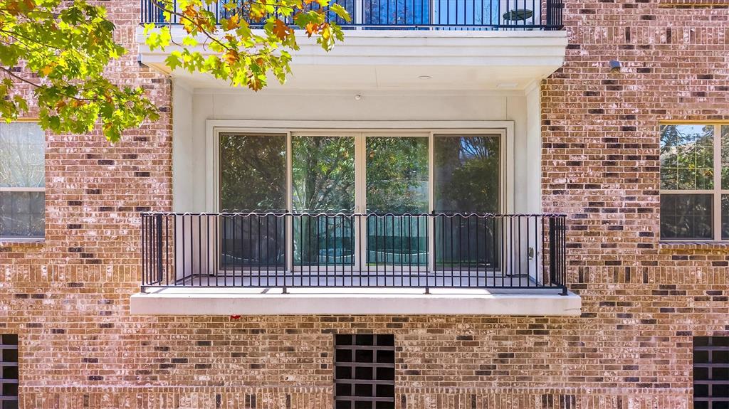 a view of a brick house with a iron gate