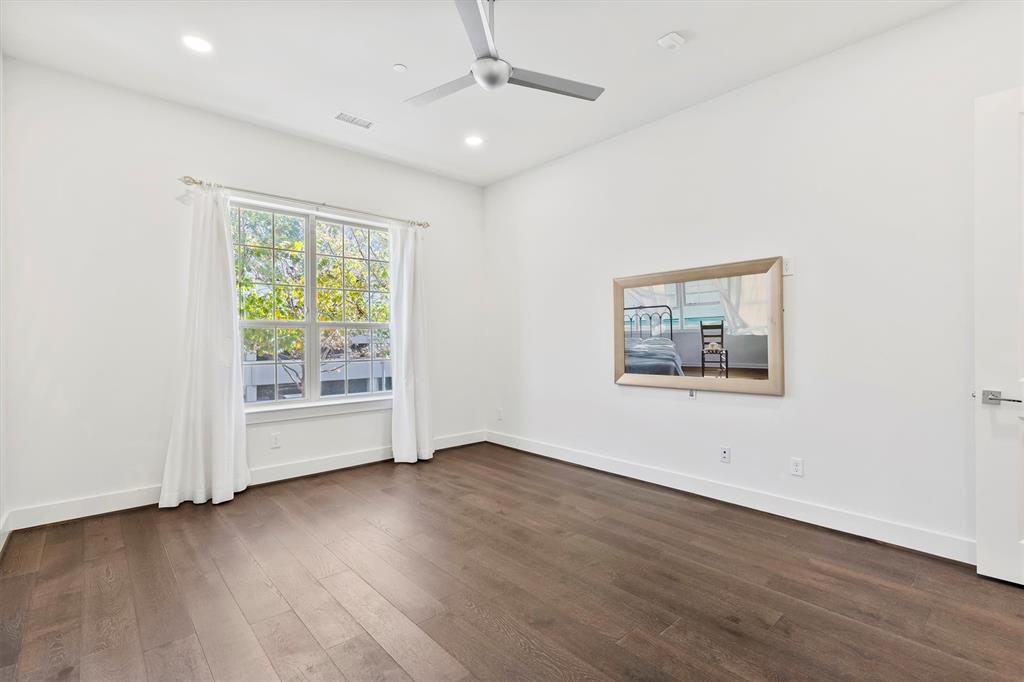 15875 Spectrum Drive, Unit 1106 Addison, TX 75001 - Photo 12 of 39 an empty room with wooden floor and windows