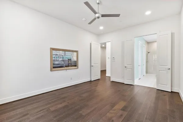 a view of an empty room with wooden floor