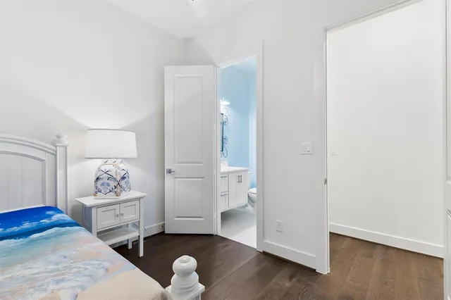 a bedroom with a bed and a potted plant