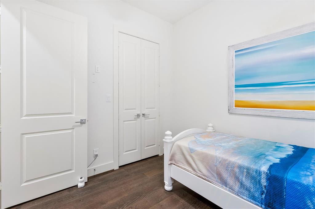 15875 Spectrum Drive, Unit 1106 Addison, TX 75001 - Photo 18 of 39 Bedroom featuring dark wood flooring and a closet. *staged to show potential*