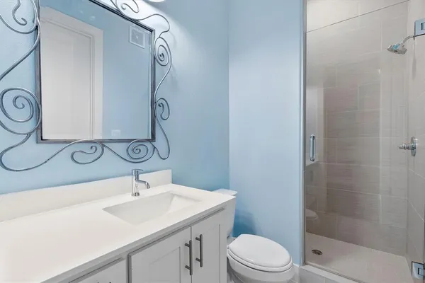 a en suite bathroom with a sink and a mirror