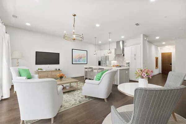 a living room with couches a coffee table and a flat screen tv
