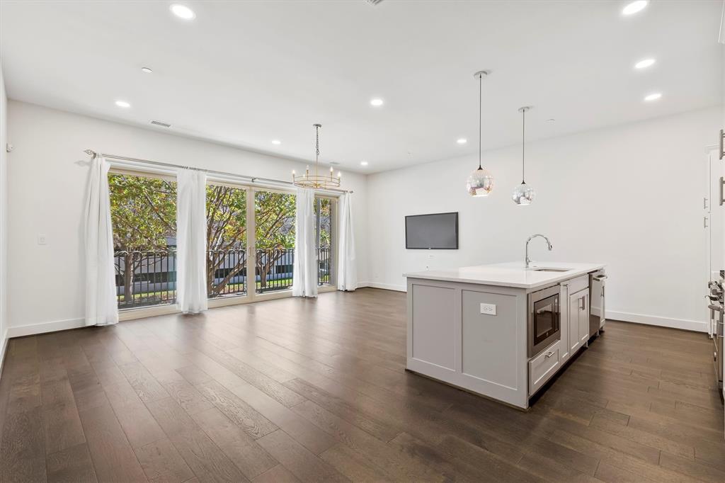 15875 Spectrum Drive, Unit 1106 Addison, TX 75001 - Photo 8 of 39 a view of an empty room with wooden floor and a window