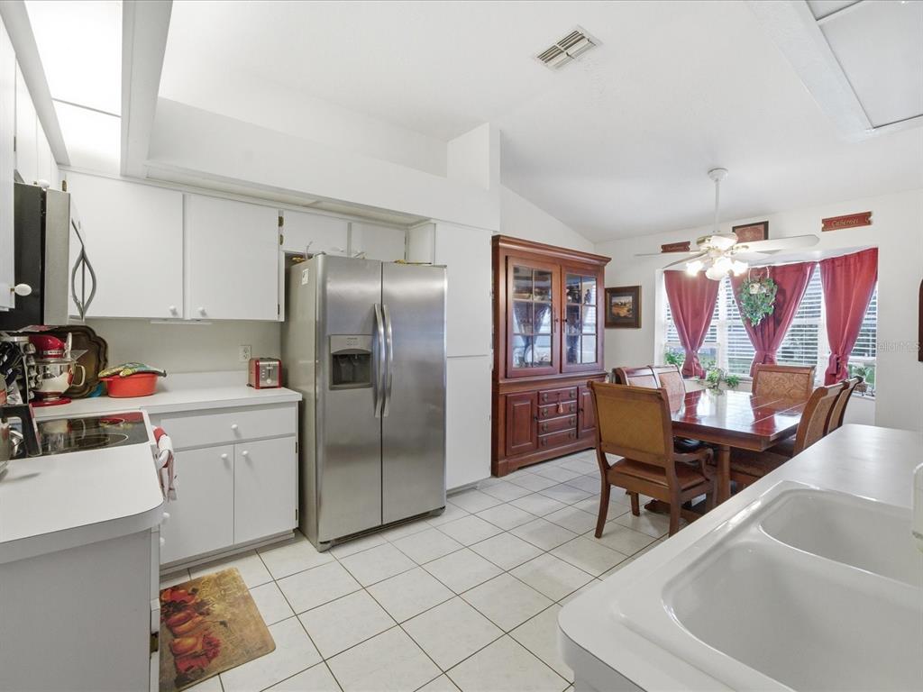 4209 Avanti Circle New Port Richey, FL 34655 - Photo 13 of 35 a kitchen with a refrigerator and a sink