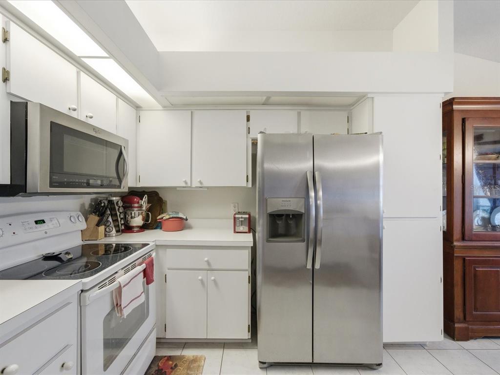 4209 Avanti Circle New Port Richey, FL 34655 - Photo 14 of 35 a kitchen with a sink appliances and cabinets
