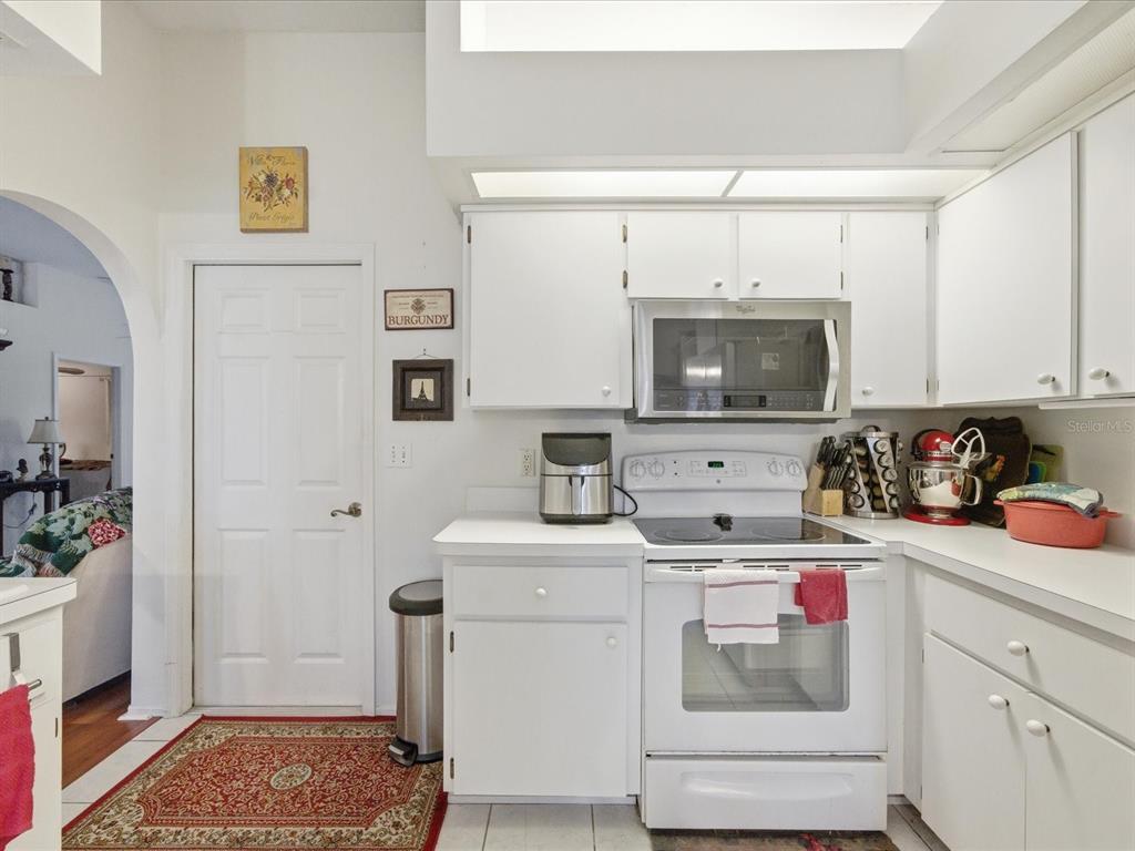 4209 Avanti Circle New Port Richey, FL 34655 - Photo 16 of 35 a kitchen with a sink a stove and cabinets