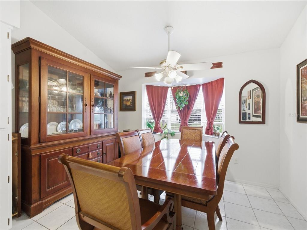 4209 Avanti Circle New Port Richey, FL 34655 - Photo 20 of 35 a view of a dining room with furniture wooden floor and chandelier