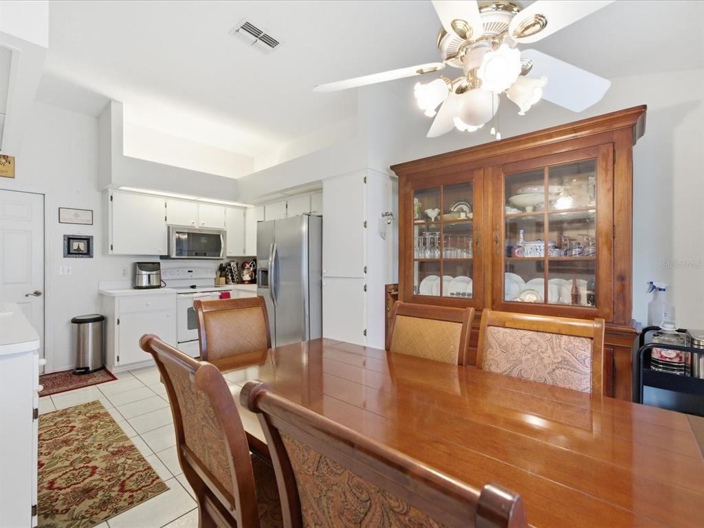 4209 Avanti Circle New Port Richey, FL 34655 - Photo 21 of 35 a view of a dining room and livingroom with furniture wooden floor a chandelier