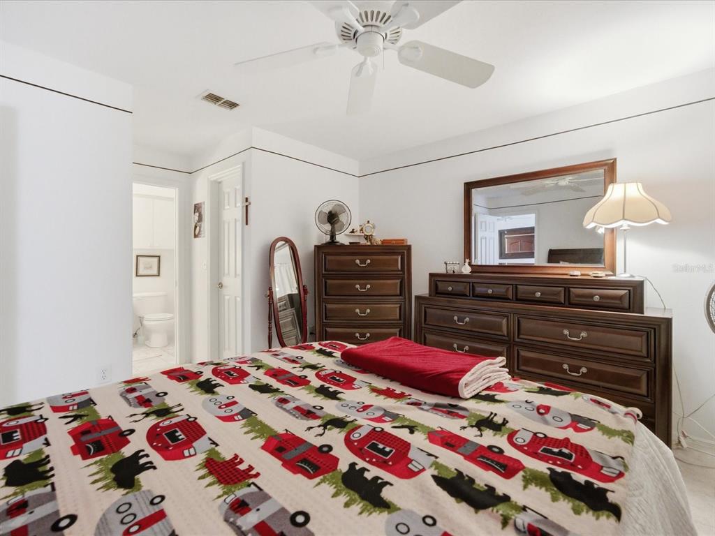 4209 Avanti Circle New Port Richey, FL 34655 - Photo 27 of 35 a bedroom with a bed and a dresser